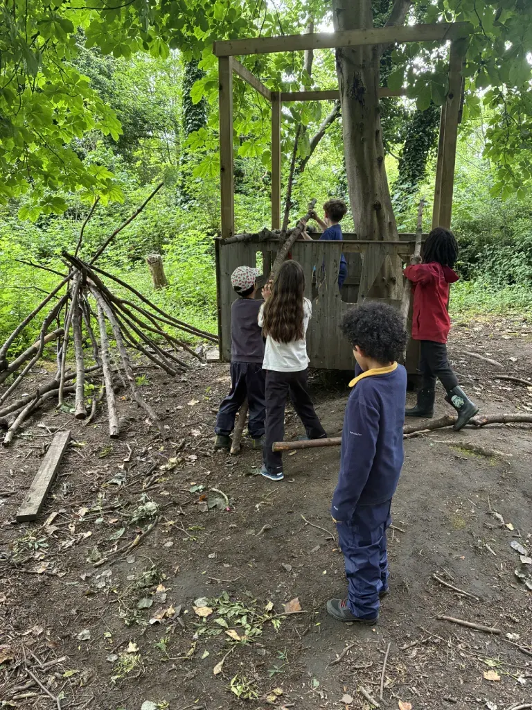 A child balancing along a fallen log in the woods